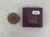 a small coin sitting next to a small box