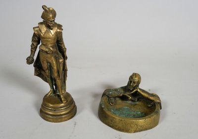 two bronze figurines of a man and a woman sitting on a fountain