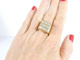 woman ' s hand with red manicured nails and a gold ring