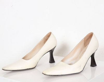 une paire de chaussures blanches à talons hauts sur une surface blanche
