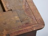 a close up of a wooden table with a piece of wood on top of it