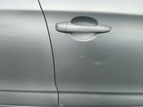 a silver car with a hole in the door handle