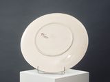 an image of a white plate sitting on top of a white pedestal