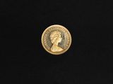a close up of a gold coin on a black surface
