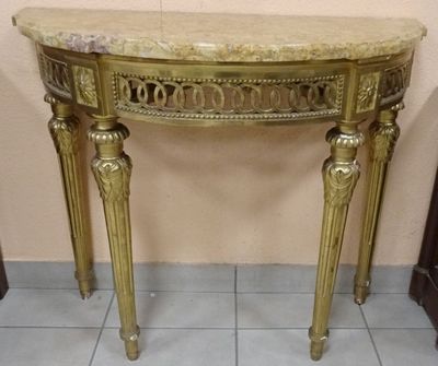 a marble top table with gold legs and a marble top
