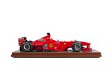 a close up of a model of a racing car on a wooden base