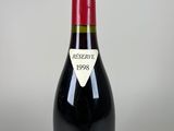bottle of chateau des tour red wine on a white background