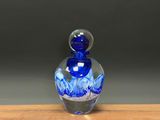 a blue glass bottle sitting on top of a wooden table