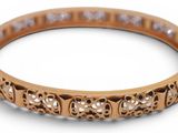 a close up of a gold bang bracelet with diamonds on it
