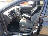 the interior of a car with the door open and the driver ' s seat up
