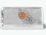 a silver wallet with a leather label on the front