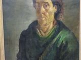 portrait of an old woman in a green shirt and a black hat