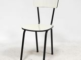 a black and white chair sitting on a white floor