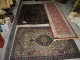 many rugs laid out on the floor in a room