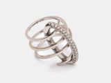 a close up of a ring on a white surface with diamonds