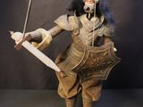 a puppet of a man holding a knife and a sword