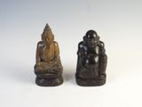 pair of carved wood buddha figurines on white background