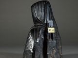 a black sculpture of a person with a hood on it ' s head