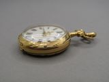 a gold pocket watch with a chain attached to it