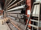 a large amount of steel pipes stacked up in a warehouse