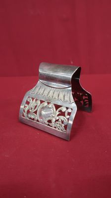 an old silver metal money box on a red cloth