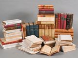 many books stacked on top of each other on a table