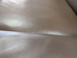 a close up view of a leather couch with a leather cover