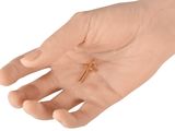 a small gold cross on the palm of a person