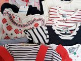 a suitcase full of clothes and a bag of clothes