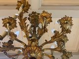 a gold chandelier hanging from the ceiling in a room