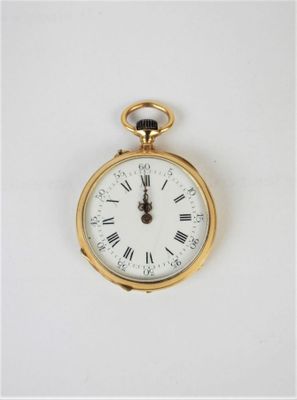 a gold pocket watch with roman numerals on the face