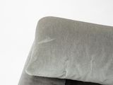 a cat that is sitting on a chair with a pillow
