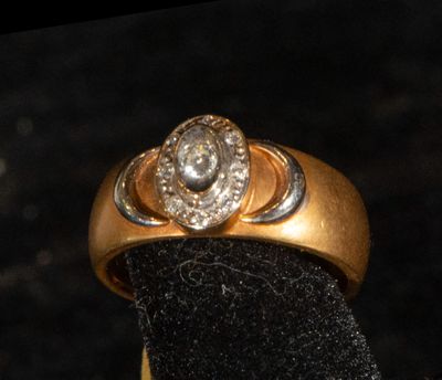 a gold ring with a diamond on top of it