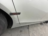 a close up of a car door with a sticker on it