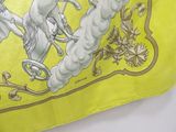 a yellow scarf with a picture of a horse and a man riding a horse