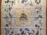 a picture of a table cloth with a picture of a woman sitting at a table