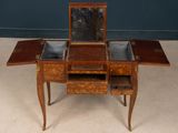 a small wooden table with a mirror on top of it
