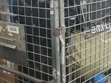 a large metal cage with luggage in it