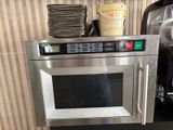 a microwave that is built into the wall in the kitchen