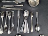 a lot of silver spoons and forks on the table