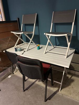 two chairs and a table in a room with blue walls