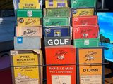 many boxes of golf cards stacked on a table