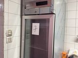a refrigerator that is in the middle of a kitchen