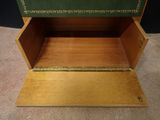 a wooden box with a green cover on top of it