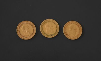 three different types of gold coins on a black surface