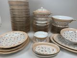 a lot of plates and bowls that are on the table