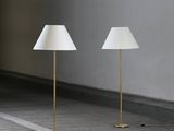 three lamps in a room with a white wall and wooden floor