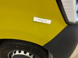 a close up of a yellow car with a sticker on it