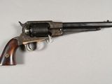 a close up of a gun on a table with a white background