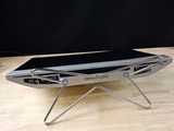 a laptop sitting on a metal stand on a table
